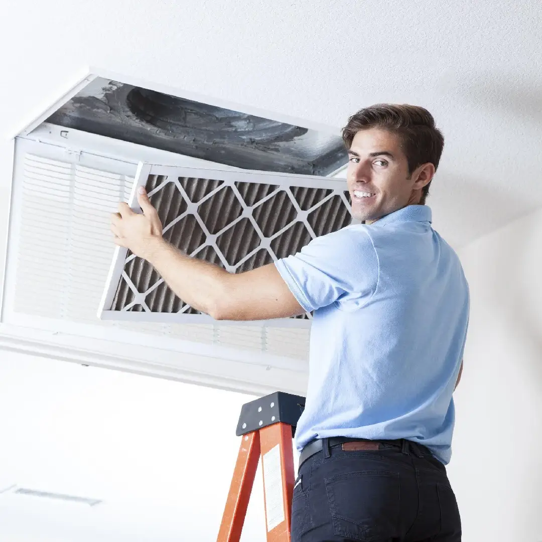 a man removing an AC filter