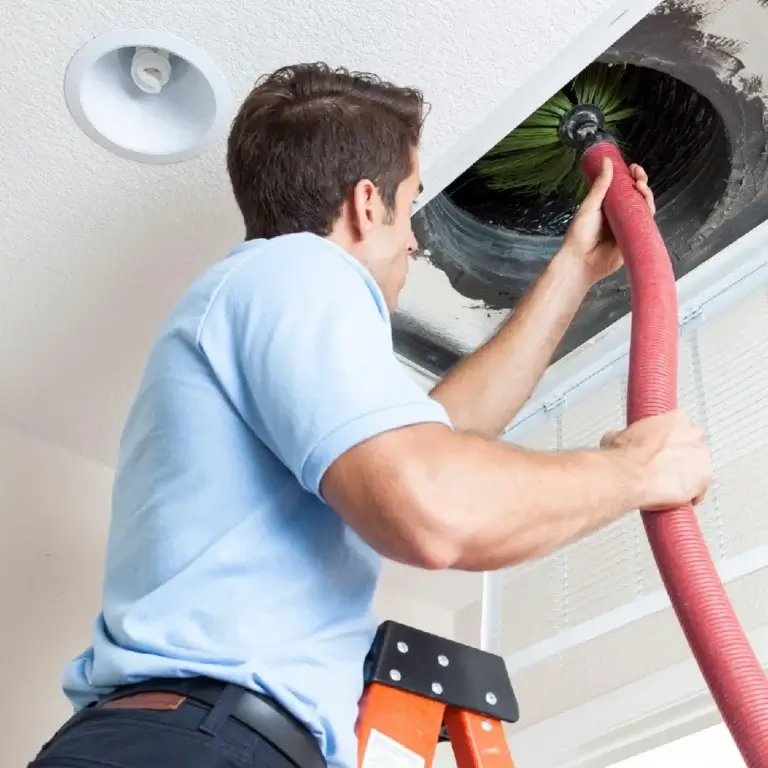 A man cleaning an AC duct in Dubai